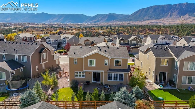 drone / aerial view featuring a residential view and a mountain view