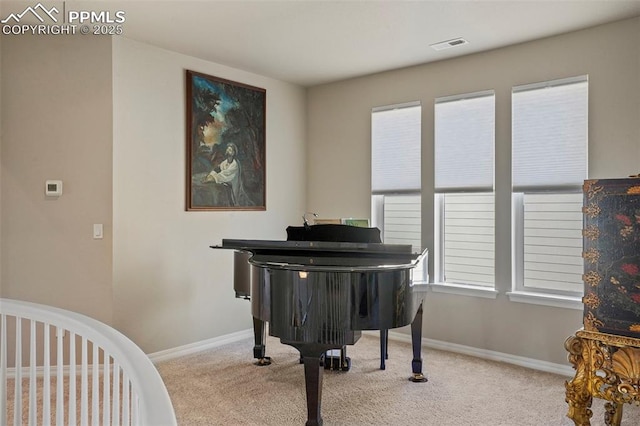 living area with visible vents, baseboards, and carpet floors