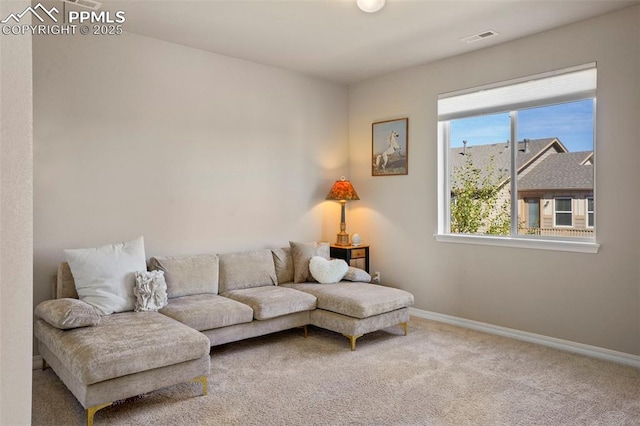 living room featuring visible vents, carpet flooring, and baseboards