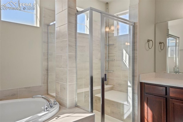 bathroom featuring vanity, a shower stall, and a bath