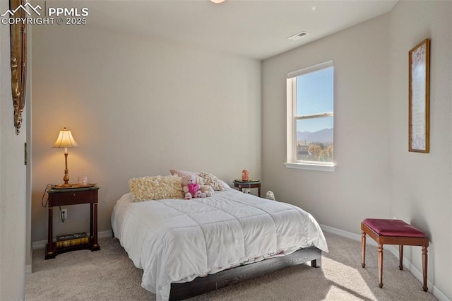 bedroom featuring visible vents, baseboards, and light colored carpet