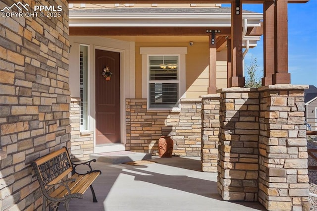 property entrance featuring stone siding