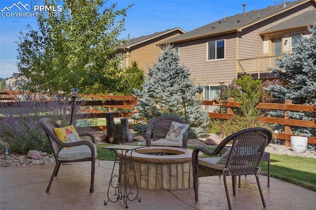 view of patio featuring a fire pit and fence