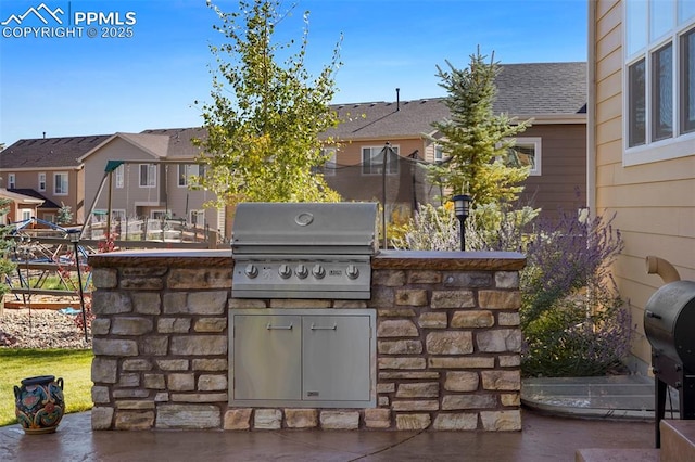 view of patio / terrace with a residential view, area for grilling, and fence