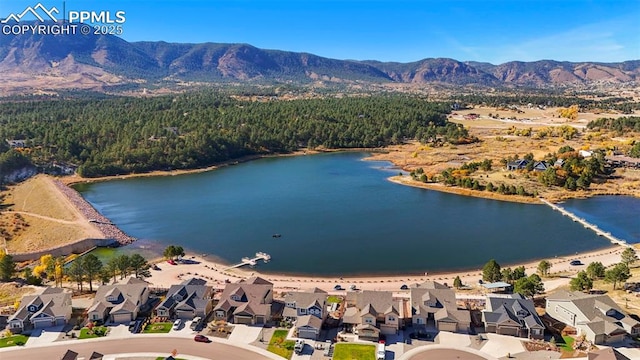 drone / aerial view with a residential view and a water and mountain view