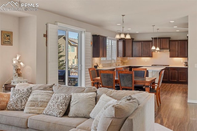 living area featuring recessed lighting and dark wood-style floors