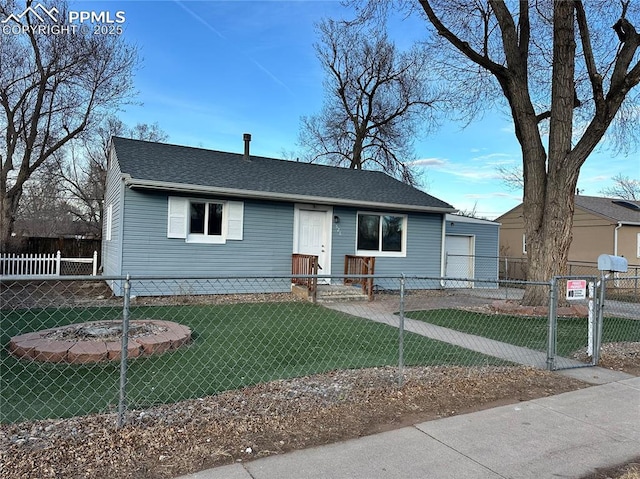 view of front of house featuring a fenced front yard, a gate, a front lawn, and roof with shingles