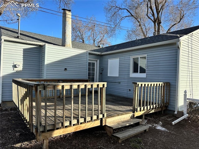 rear view of house with a wooden deck