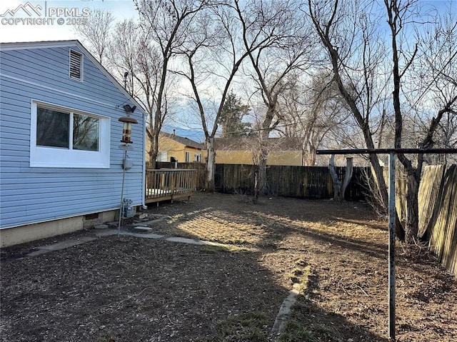 view of yard with a deck and a fenced backyard