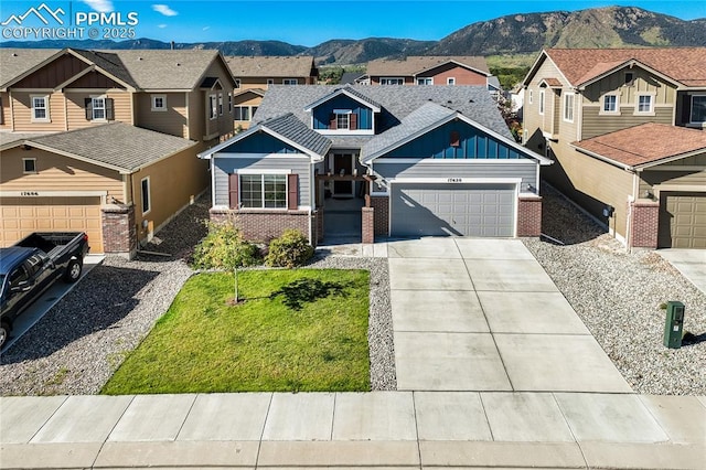 craftsman inspired home featuring a residential view, brick siding, a mountain view, and an attached garage