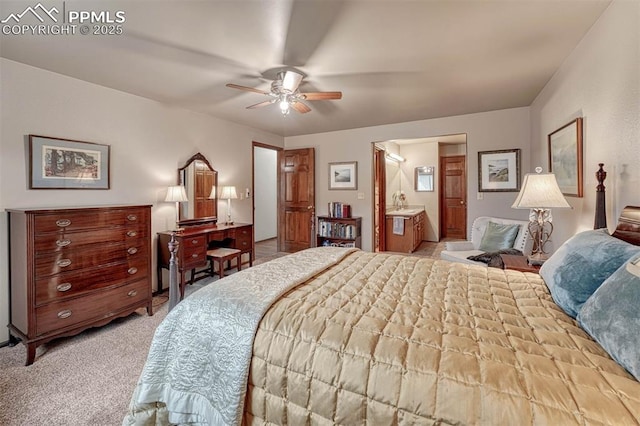 bedroom featuring ceiling fan, connected bathroom, and light colored carpet