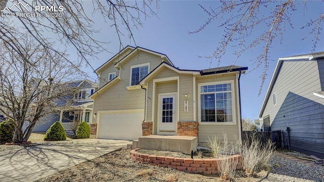 view of front of property with concrete driveway, brick siding, and an attached garage