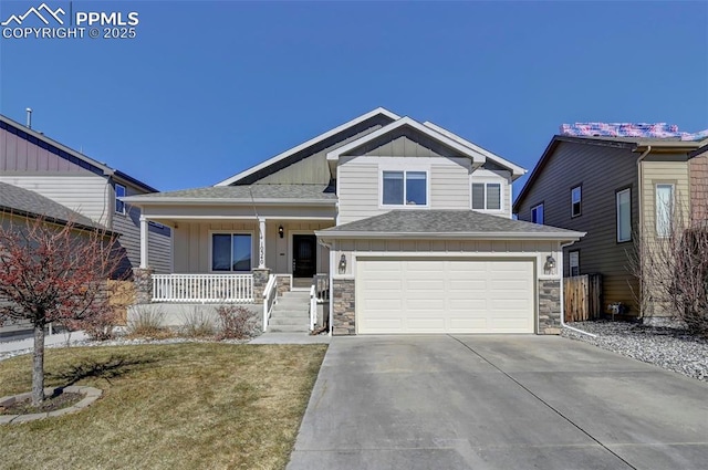 craftsman-style house featuring driveway, stone siding, a porch, and board and batten siding