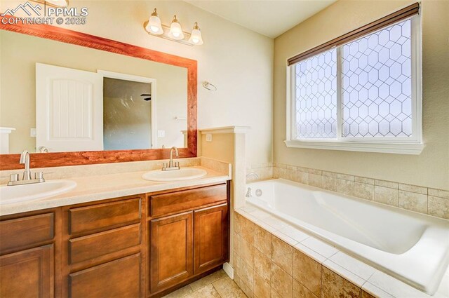 full bath with double vanity, a sink, tile patterned floors, and a bath