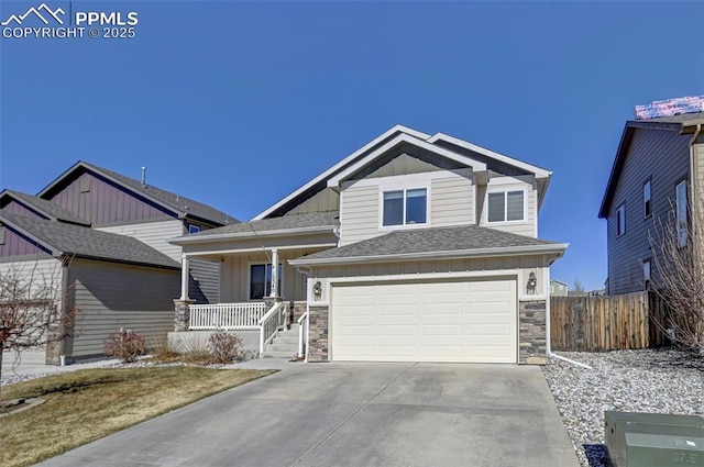 craftsman-style home with an attached garage, covered porch, stone siding, and board and batten siding