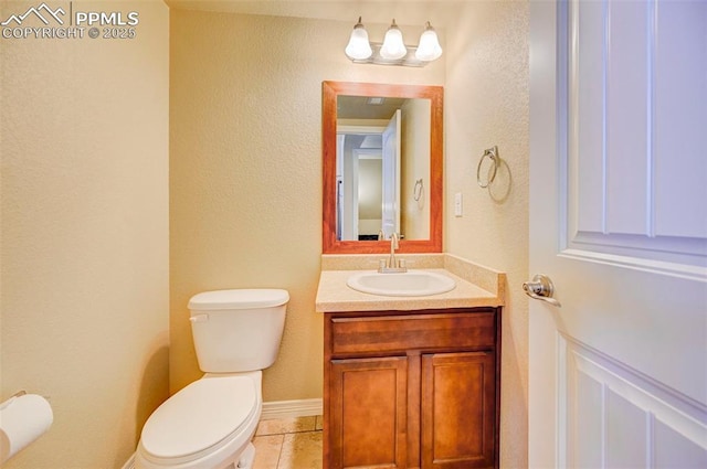 bathroom featuring toilet, vanity, and tile patterned floors