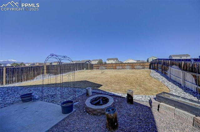 view of yard with an outdoor fire pit, a fenced backyard, and a patio area