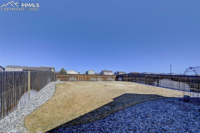 view of yard with a fenced backyard