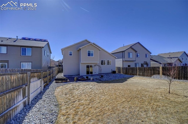 rear view of property with a fenced backyard