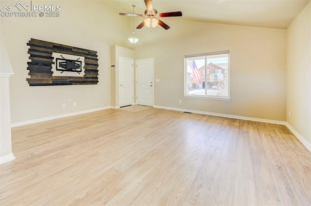 unfurnished living room with light wood-style flooring, baseboards, lofted ceiling, and ceiling fan