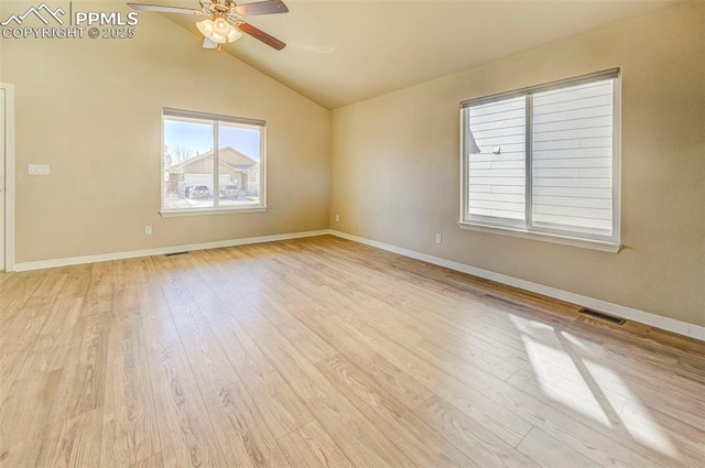 empty room with visible vents, baseboards, ceiling fan, light wood-type flooring, and vaulted ceiling