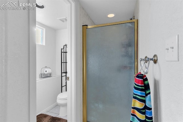 full bath featuring toilet, a stall shower, visible vents, and tile patterned floors