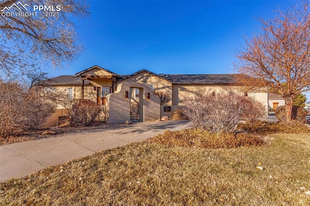 view of front of house featuring driveway and stucco siding