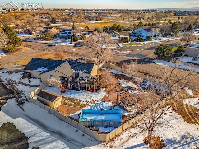 snowy aerial view featuring a residential view