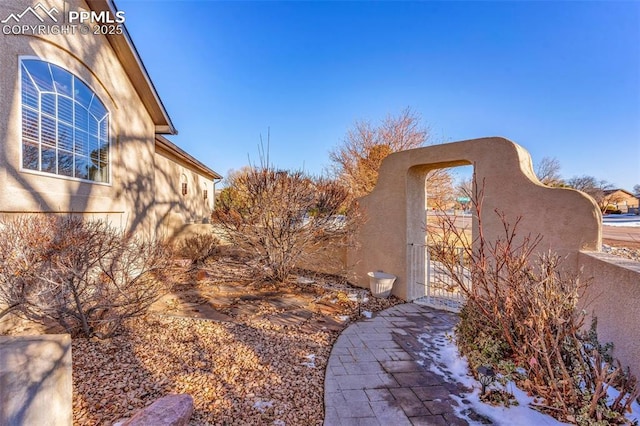 view of side of property with a gate