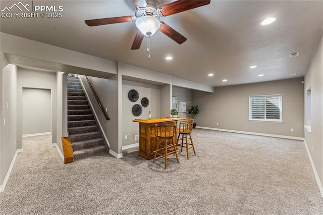 interior space with stairs, a dry bar, baseboards, and recessed lighting