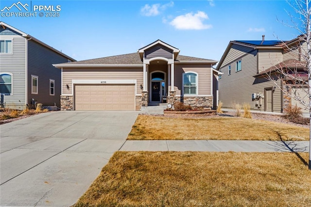 craftsman-style house with a front yard, stone siding, driveway, and an attached garage