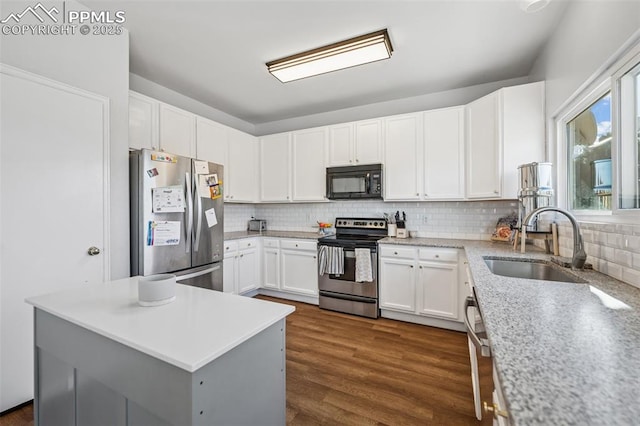 4925 Hawk Meadow Dr, Colorado Springs, CO 80916 - kitchen with dark wood-style floors, stainless steel appliances, a sink, and decorative backsplash