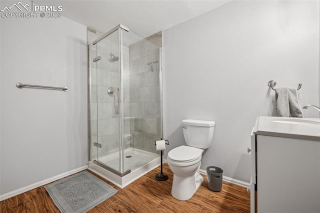 4925 Hawk Meadow Dr, Colorado Springs, CO 80916 - bathroom with toilet, a shower stall, wood finished floors, and vanity