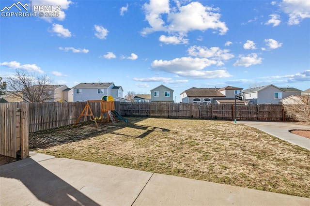 4925 Hawk Meadow Dr, Colorado Springs, CO 80916 - view of yard with a fenced backyard, a residential view, a playground, and a patio
