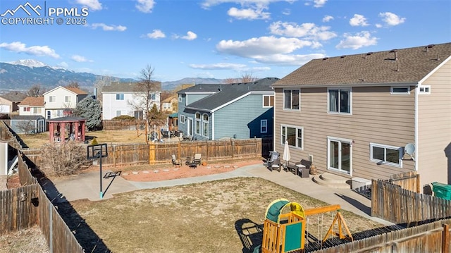 4925 Hawk Meadow Dr, Colorado Springs, CO 80916 - back of house featuring a residential view, a patio area, a mountain view, and a fenced backyard