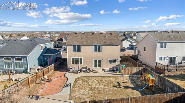 4925 Hawk Meadow Dr, Colorado Springs, CO 80916 - rear view of property with entry steps, a patio, a fenced backyard, a residential view, and a playground