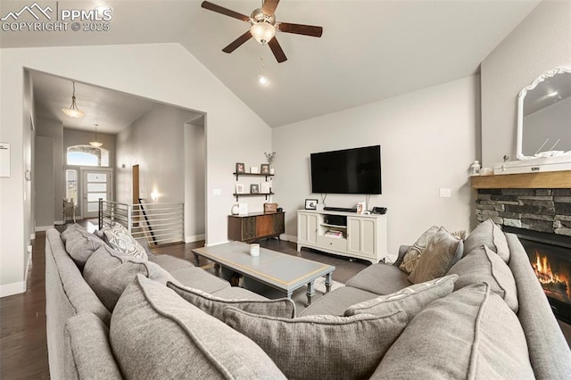 living room featuring baseboards, dark wood finished floors, ceiling fan, a fireplace, and high vaulted ceiling