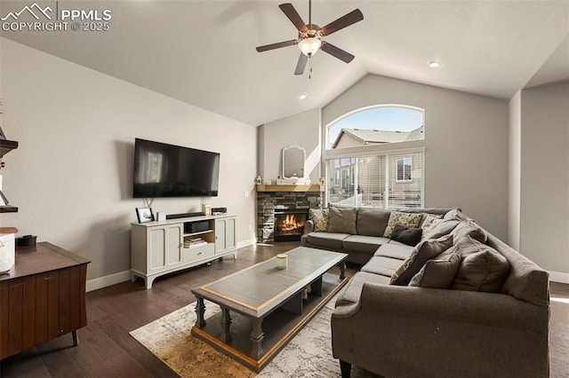 living room featuring dark wood-style floors, a fireplace, a ceiling fan, vaulted ceiling, and baseboards