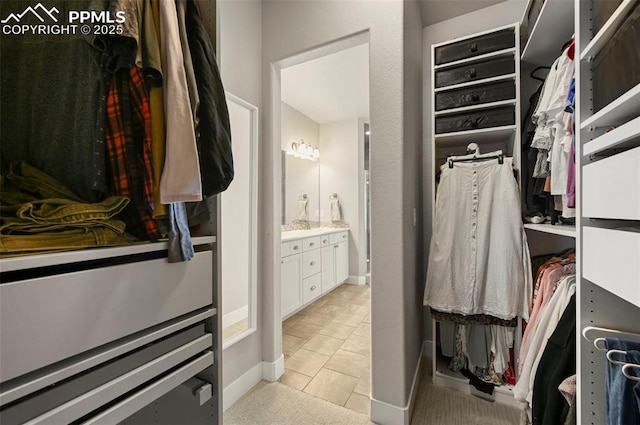 spacious closet with light tile patterned floors