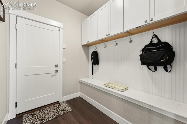 mudroom with dark wood-style floors and baseboards