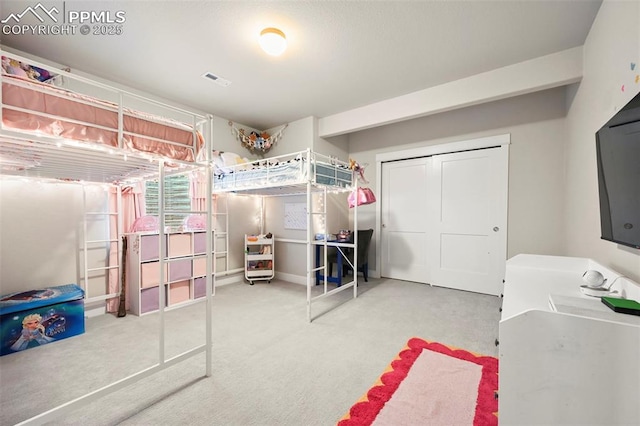 bedroom with carpet and a closet