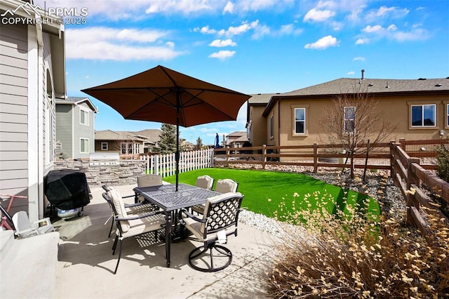 view of patio / terrace with an outdoor kitchen, a fenced backyard, outdoor dining area, and area for grilling