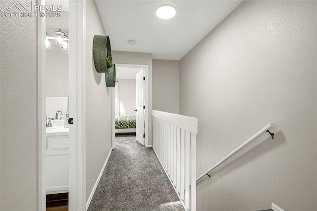 1908 Giltshire Dr, Colorado Springs, CO 80905 - hallway featuring carpet flooring, baseboards, and an upstairs landing