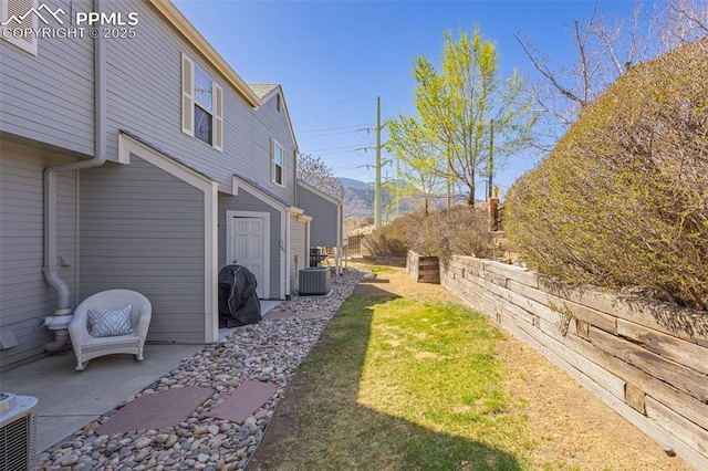 1908 Giltshire Dr, Colorado Springs, CO 80905 - view of yard with central AC unit, a mountain view, and a patio