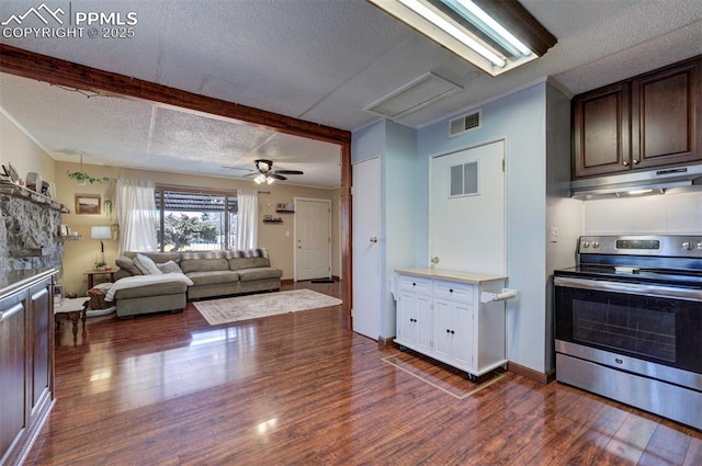 kitchen featuring stainless steel range with electric stovetop, visible vents, dark wood finished floors, and under cabinet range hood