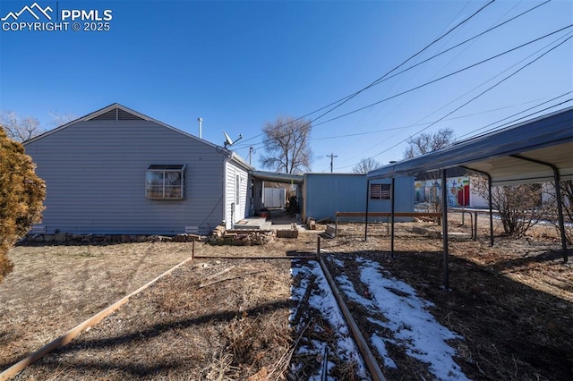 back of property featuring a carport