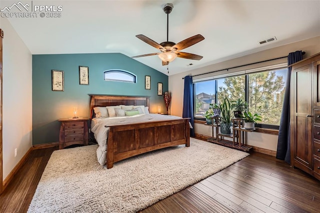 bedroom featuring lofted ceiling, dark wood-style floors, visible vents, and baseboards