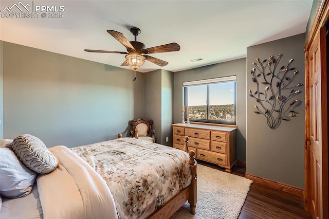 bedroom featuring a ceiling fan, visible vents, baseboards, a closet, and dark wood-style floors