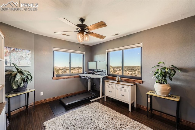 workout area with a ceiling fan, visible vents, dark wood finished floors, and baseboards