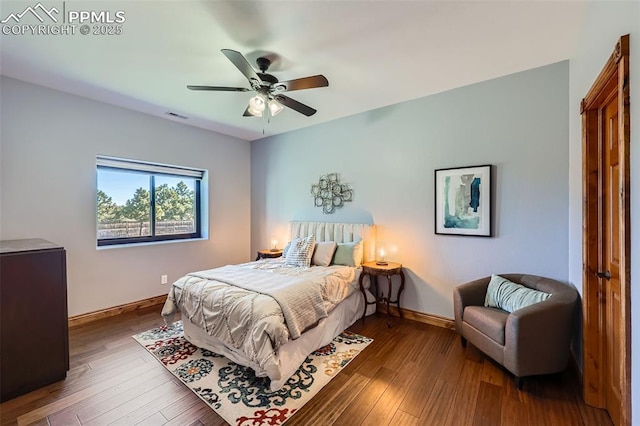 bedroom with wood-type flooring, visible vents, ceiling fan, and baseboards